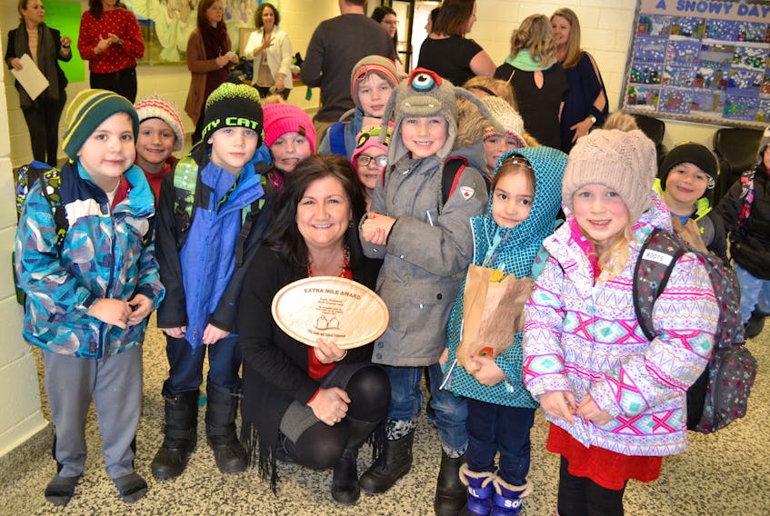 Before heading home for the day, Tracy Arsenault’s Grade 1 students from Ellerslie Elementary gather around to celebrate her Extra Mile award.