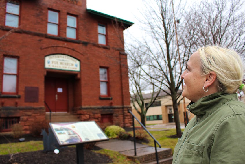 Lori Ellis looks up at the former armoury building in downtown Summerside. Ellis, the manager of heritage and cultural properties for Culture Summerside, is looking forward to seeing the historic building gain new life in the new year.