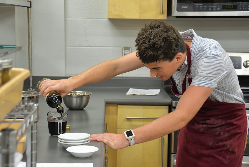 Three Oaks Senior High School student Caleb Dawson measures out a balsamic vinegar in the school’s newly renovated culinary labs. (Colin MacLean/Journal Pioneer)