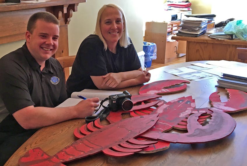 Jordan Ellis of Spud FM, left, and Lori Ellis of Culture Summerside, organizers of the Summerside Lobster Carnival, share a few laughs as they plan out the Summerside Lobster Carnival Lobster Photo Competition being sponsored by SPUD FM, CFCY and Q 93 radio stations.