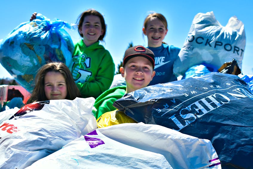 Abbi Poirier, from the front left, and Harrison Ramsay. From the back left: Chloe Hardy and Lilly McDermaid in the van with more than 20,000 single-use plastic bags to be reused and recycled.