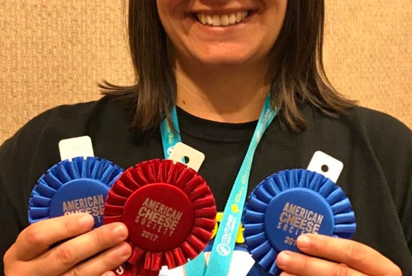 Cows Creamery wholesale manager, Andrea White, proudly displays ribbons from the American Cheese Society Competition.