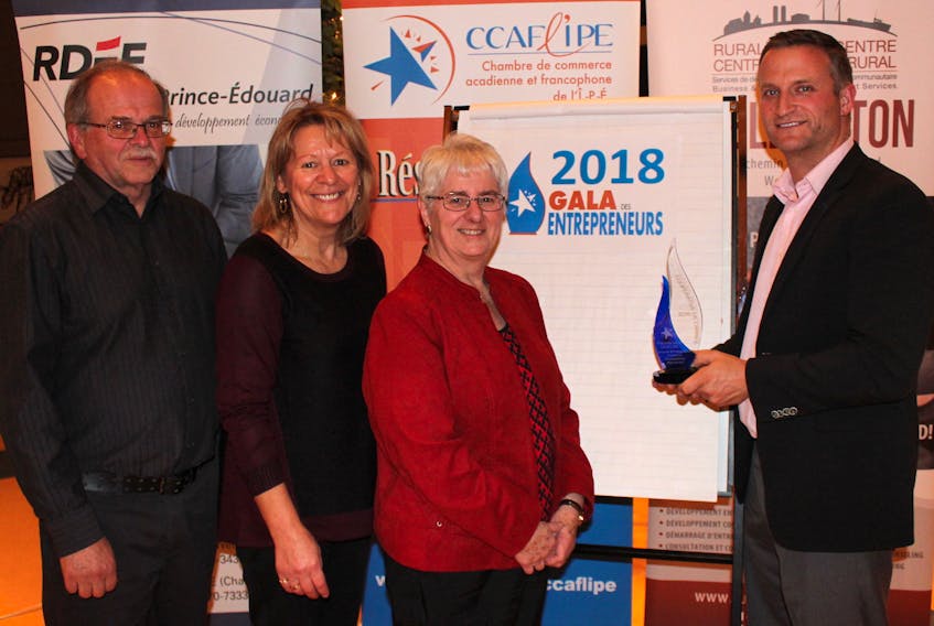 Pierre Gallant, right, spokesperson for the Acadian and Francophone Chamber of Commerce of P.E.I., teases three of the finalists from the Chamber’s business award with one of the championship trophies. From left are finalists Alcide Bernard, president of the Agricultural Exhibition and Acadian Festival, Jeannette Gallant, a camp leader with the Centre Goéland - Village des Sources l’Étoile Filante, and Jeannette Arsenault, co-owner of the Shop & Play tourist gift shop in Borden-Carleton.