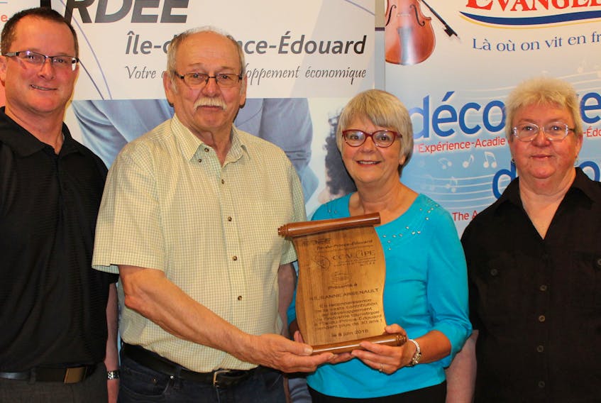 Réjeanne Arsenault, second from right, former owner of The Bottle Houses in Cape Egmont, was recognized for her contribution to the development of the tourist industry by three provincial organizations. She is seen with their representatives, from left, Martin Marcoux, president of RDÉE P.E.I., Marcel Bernard, president of l'Association touristique Évangéline, and Diana Larivière, board member of the Acadian and Francophone Chamber of Commerce of P.E.I.