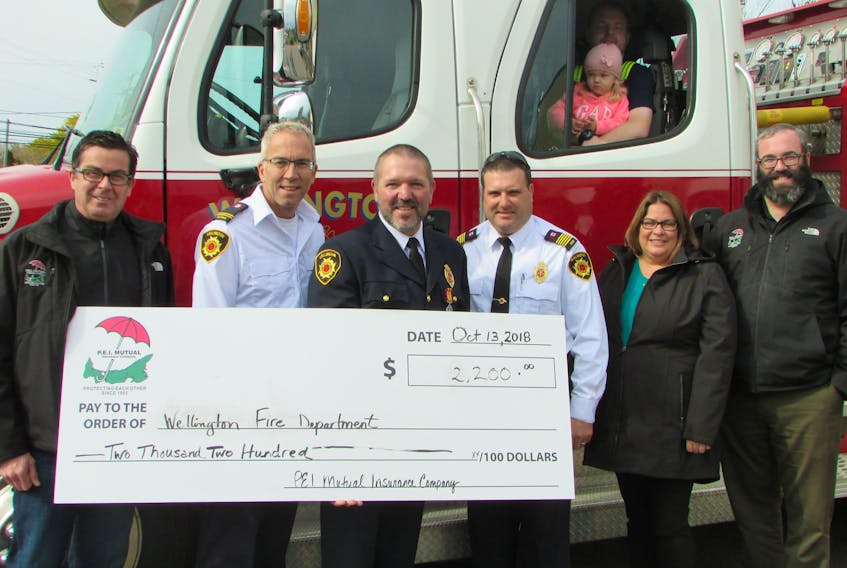 PEI Mutual representatives present a cheque for $2,200 to the Wellington Fire Department representing donations in 2017 and 2018. On hand for the presentation, center, Wellington Fire Department President Desmond Arsenault, Deputy Chief Leon Perry and Chief James Ryan. PEI Mutual Director Shane MacKinnon, left, Agent Jane MacLaurin second from right and Safety Surveyor Gary Bryson.