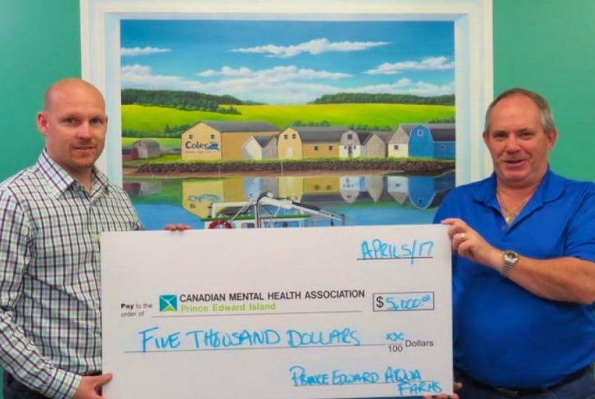 As the presenting sponsor for the event, Prince Edward Aqua Farms, represented here by general manager, Jerry Bidgood (right), presents a cheque to Kevin Wile (left), Spring Gala committee member.