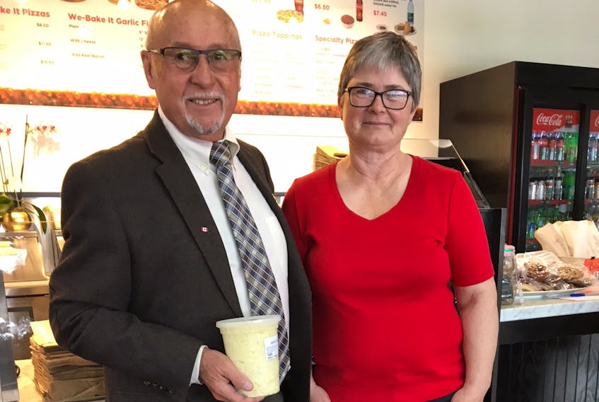 Bakery owner Bill Martin, and Marlene Campbell of Culture Summerside, organizers of the Summerside Lobster Carnival, pose with a tub of the bakery’s potato salad, one of the stars of the carnival lobster suppers.
