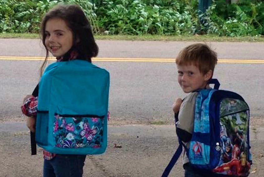 Kate, 10, and Jed Kennaugh, 7, have their backpacks loaded with school supplies, but like they’re mom Chere, they’ll calling for help to fulfill about 650 requests to Operation Backpack for backpacks and schools supplies from Island families in need.