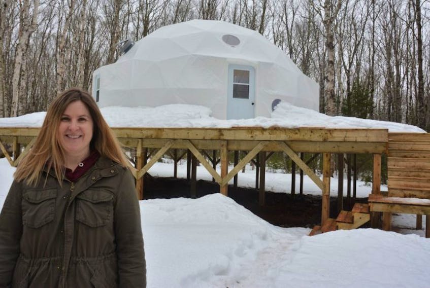 Sheila Arsenault, owner of Treetop Haven, outside one of her geodesic domes.