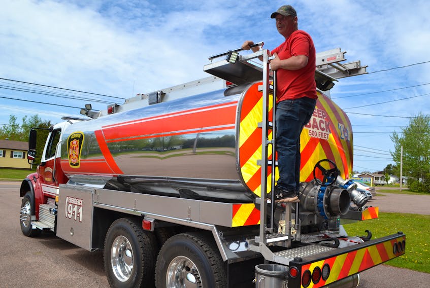 Shannon Dumville, chief of the Alberton Fire Department, checks out the department’s new tanker. The unit, which has a 3,000-gallon aluminum tank on a 2019 Freightliner chassis, arrived June 6 and was added to the department’s fleet the following evening. It replaces a 1989 Ford tanker.