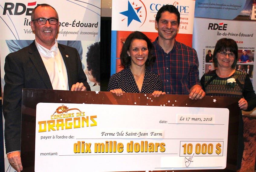 Chris Palmer, minister of economic development and tourism, from left, presents the $10,000 Dragons’ Contest cheque to champions Deirdre and Gabriel Mercier from Isle Saint-Jean Farm in North Rustico, along with contest co-ordinator Velma Robichaud.