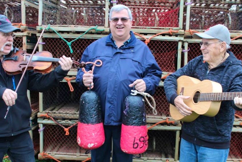 Fiddling fisherman Norman Arsenault, left, and his father, retired fisherman and guitar player, Amand Arsenault, right, will entertain those who attend the Pioneer Francophone Fishermen’s luncheon on Nov. 29, at the Acadian Musical Village in Abram-Village.
