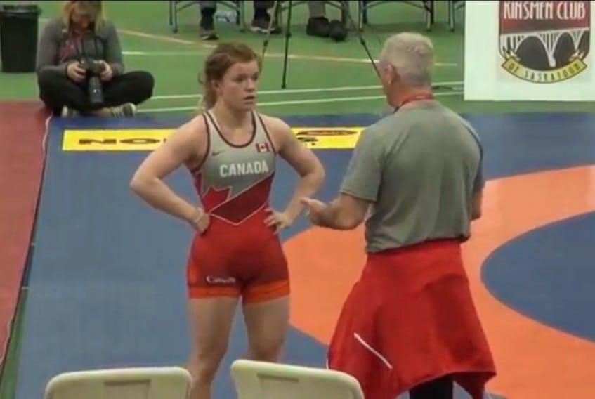 Hannah Taylor discusses strategy with Brock Wrestling Club head coach Marty Calder.