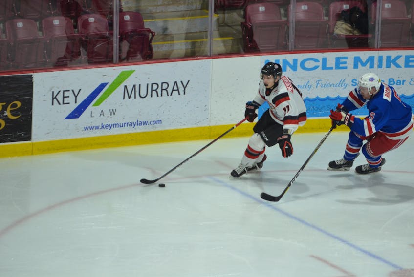Pictou County Crushers forward Sam Meisenheimer looks to protect the puck from Summerside Western Capitals defenceman Brodie MacMillan during Wednesday night’s MHL (Maritime Junior Hockey League) game at Eastlink Arena. The Caps, who won the game 7-3, return home to host the Miramichi Timberwolves on Saturday at 7 p.m.