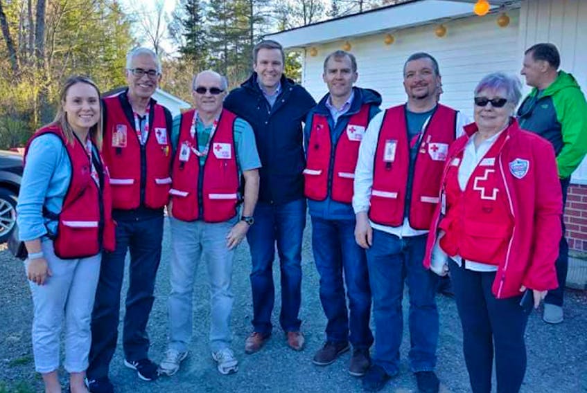 Canadian Red Cross volunteer Jamie MacKay and interim provincial director Bill Lawlor, second and third from right, were deployed volunteers at the New Brunswick floods earlier this year.