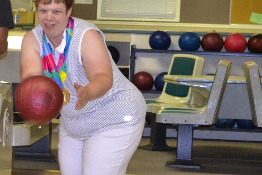 Jenna Smith, a triple gold medalist in 10-pin bowling at the 2015 Special Olympics World Games, shows how to roll a strike. The Tyne Valley Firemen’s Club recently received federal and provincial funding to upgrade its bowling lanes and carry out other expansion and renovation projects.