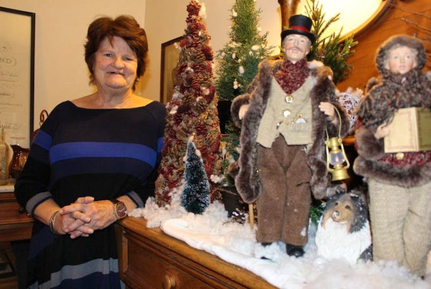 Estelle Dalton stands next to her favourite Christmas display, "the carolers".
