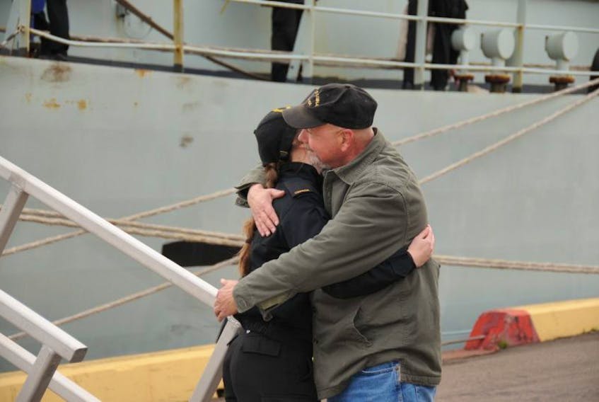 Retired sailor Denis Riviere greets his daughter, Ordinary Seaman Elizabeth Riviere, at the dock in Summerside, just like she used greet him many years ago.