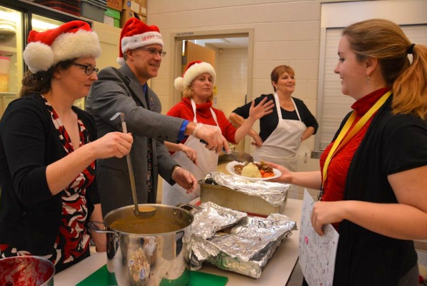 Kinkora regional High School holds an annual turkey dinner for its staff and students. Serving up this year’s meal was, from left: Stephanie Browne, Kevin Stewart, Janice Broderick and Janet Surette and getting served was Ashley Greening.