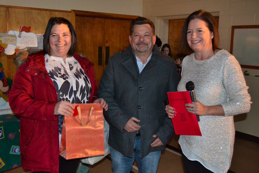 Alberton Elementary School principal Shanna Perry, right, acknowledges Della and Dennis Rix, owners of Alberton Pharmacy, for their donation of an automated external defibrillator (AED) for the school.