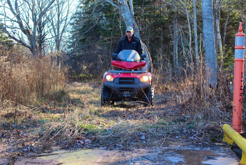 JP Gallant, president of the Evangeline ATV Club, drives his ATV to a bridge the club has built near its clubhouse in Mont Carmel. The club is building bridges and extending its trail system.