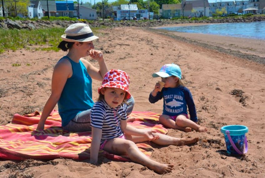 After a number of days of wet, cold weather the Brunel family, including Lucile and her daughters Nola, front, and Carlie, rear, eagerly took an opportunity Thursday to enjoy some sun along Green’s Shore. Thursday’s temperatures were among the highest Summerside has experienced so far this spring, reaching 27 C degrees.