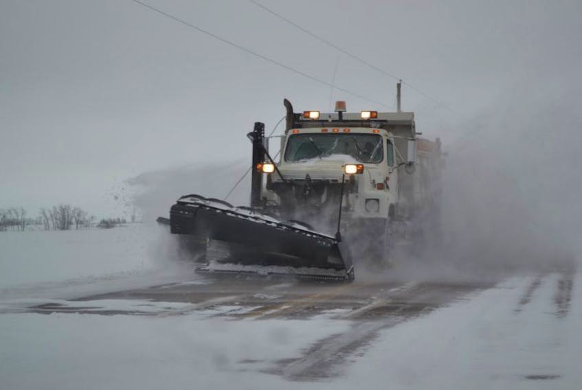A snowplow kicks up a drift as it makes its second pass on the O'Halloran Road in Bloomfield Tuesday morning. The cleanup from the blizzard that blew in Monday afternoon is well underway.