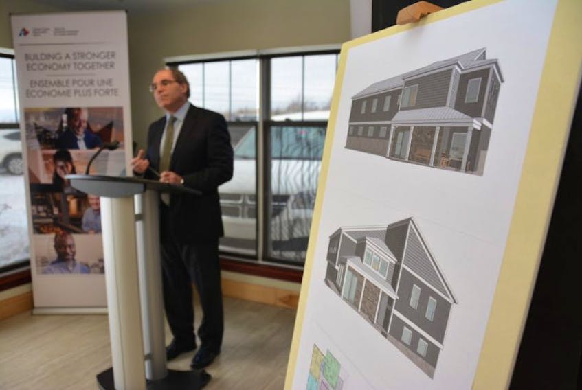 Frank Costa, executive director of Community Connections, speaks with visitors during a funding announcement at the organization's Summerside facility, Thursday.