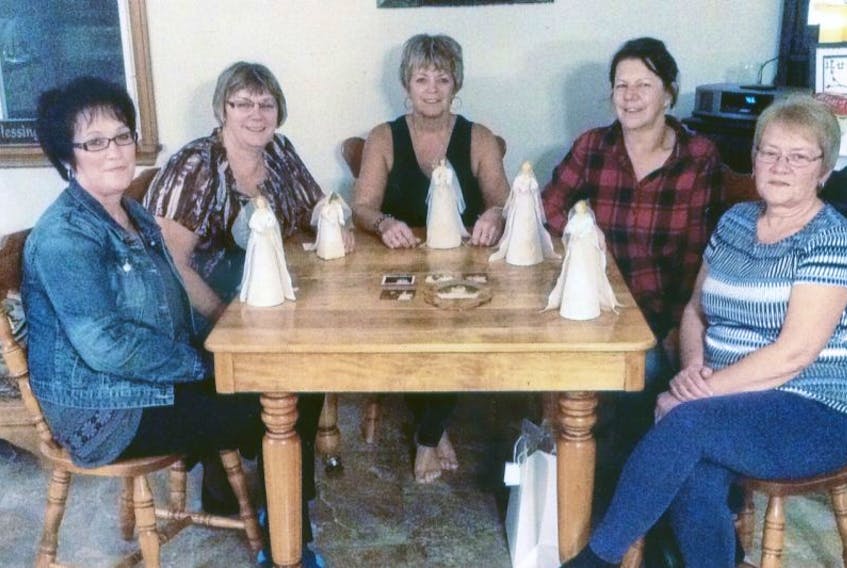 Lois Gaudet, from left, Mary Gallant, Donna LeClair, Patsy Gavin and Sylvia Ellsworth display the miniature doll brides Gavin made from the same bridal gown all five women wore for their weddings between 1974 and 1978.