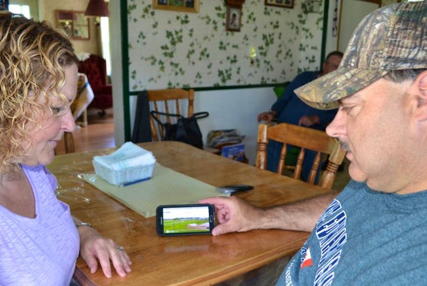 Ivy and Barry Perry, viewing a live video feed of their Timberlea neighbourhood while back in P.E.I. last spring. The Island natives hastily retreated from their Fort McMurray home on May 3, 2016, when wildfires threatened their city.