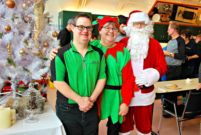 Special Olympics athlete Paul Phillips, from left, Twila Arsenault, Cooking School community coordinator with Atlantic Summerside Superstore, and Santa Claus. Arsenault said, “This is a fundraiser for the Special Olympic athletes for them to attend events outside of the province.”