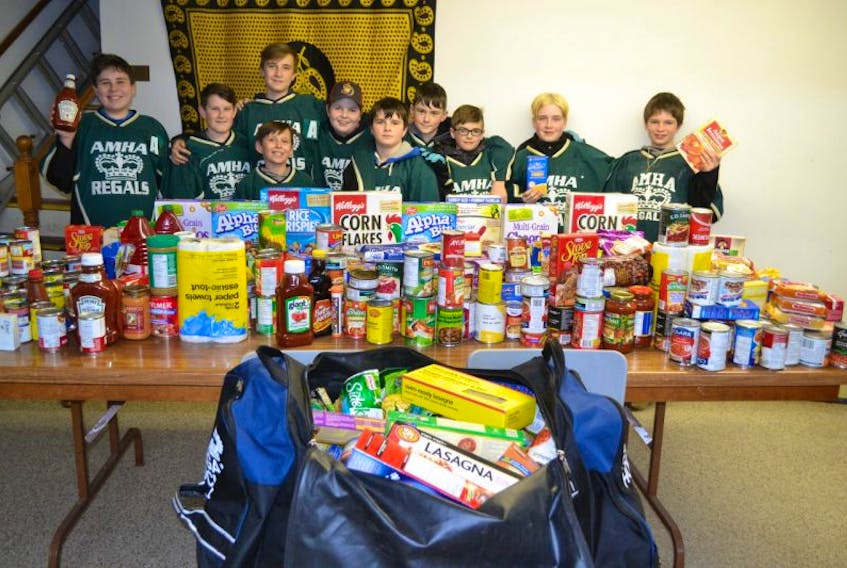 Members of the Alberton Pee Wee A Regals display a sampling of the food they collected during a food drive in support of the West Prince Caring Cupboard in February. Team members are, front row from left, Dakota Williams, Ian O’Brien; back row, Dylan Gallant, Brandon Williams, Ethan O’Brien, Lucas Skerry, Carson Dunbar, Noah Perry, Julian Perry, Lance Arsenault and, missing Bryce Silliker and Brant Hudson. The team is the P.E.I. finalist for Chevrolet’s Good Deeds Cup. Online voting to decide the champion starts Thursday.