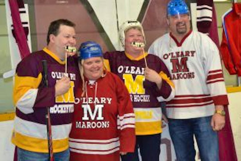 ['Dean Getson, left, a member of the O’Leary Hockeyville committee, poses with family members during the Kraft Hockeyville announcement party Saturday afternoon at the O’Leary Community Sports Centre.']