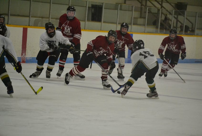 An Alberton Regals defender attempts to clear the puck as four members of the O’Leary Pee Wee Maroons charge in. The teams were playing in the opening game of the Mill River Resort Hockey Classic Friday morning in O’Leary.