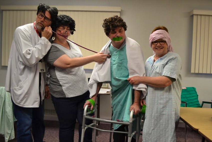 Mike Ford, from left, as the nurse and nurse Robin Dunn as Dr. Lion, team up to check the vitals of their patient, Dr. Phil Hansen while fellow patient, Diane Hogan from the Skit n’Skof comedy team is only too happy to help. Western Hospital staff and Skit n’ Skof members are teaming up Friday to present the hospital’s variety show.