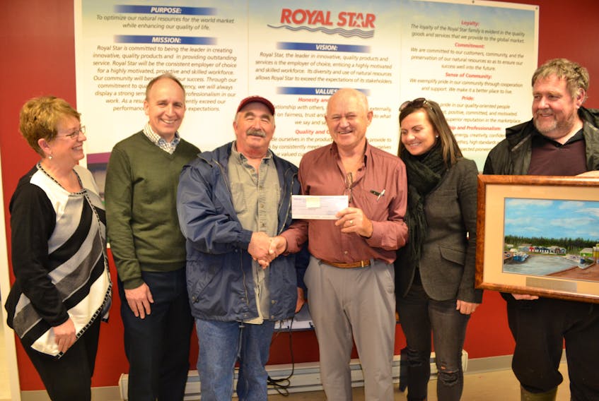 Ted Grant, third right, president of Mikinduri Children of Hope, accepts Royal Star Foods’ $10,407 contribution for children of Kenya from member fisherman David Getson. Looking on from left are Gaylene Smith, Mikinduri vice-president, Paul Crant, Rotary Club of Charlottetown, Nancy Hamill, Mikinduri volunteer and Royal Star Foods president Francis Morrissey.