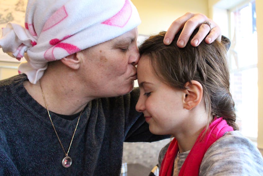 Misty-Lynn Caseley gives her daughter, Charisma a peck on the forehead. Caseley was diagnosed with breast cancer earlier this year. Recently a benefit held in Caseley’s name has provided financial security for the Christmas season.