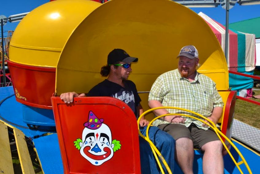 Prince County Exhibition president Jason Rayner, right, chats with Hinchey’s Rides and Amusements’ midway worker, Kenny “Ducky” Earle.  Earle revealed that the Tilt-a-whirl was his favourite ride when he was a kid and now he gets to operate the ride. He said he enjoys getting back to Alberton and renewing friendships.