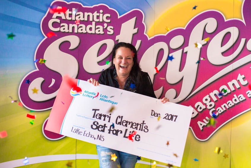 Terri Clements displaying her Set for Life grand prize. She opted for the $675,000 lump sum payment.