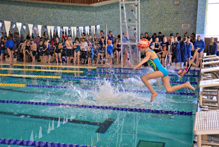 Jade Archibald, 8, of Summerside Dolphins Swim Club, dives into the Credit Union Place swimming pool as she competes in the 25-metre freestyle race