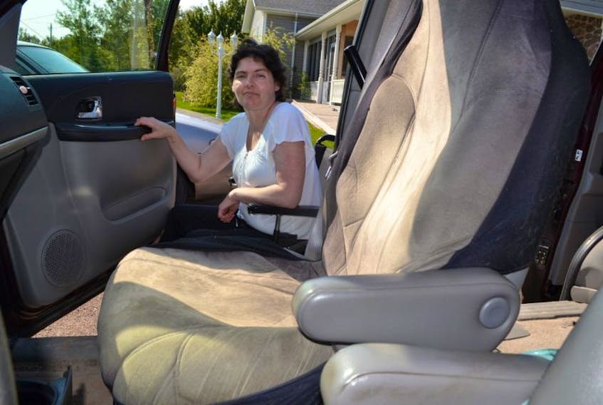 It’s a long way up from Lisa Doucette’s wheelchair to the passenger seat of her family’s van. A committee is trying to raise the money to buy her a wheelchair accessible van.