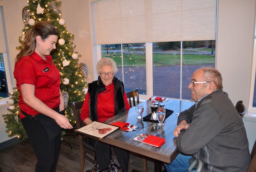 Waitress Emma McAlduff greets diners Goldie and Erskine MacMillan, back for their second meal since Our Family Traditions Restaurant opened in Tignish earlier this month.