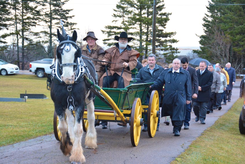 Gary Allen, left, and Elwin Sharpe drove Mickey the Clydesdale as she carried the casket of their friend, Wayne Bernard, to his final resting place in Springbrook on Wednesday.