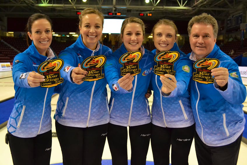 Displaying the crests their team will be wearing at the Tim Hortons Roar of the Rings Olympic qualifier next month in Ottawa are the members of the Julie Tippin rink from Woodstock, Ontario, Tippin, Chantal Duhaime, Rachelle Vink, Tess Bobbie and coach Barry Westman.