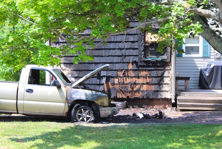 The burned remains of a truck sit in the driveway of a home at the corner of Arcona Street and Victoria Road in Summerside. The fire spread from the truck to the home before it was extinguished.