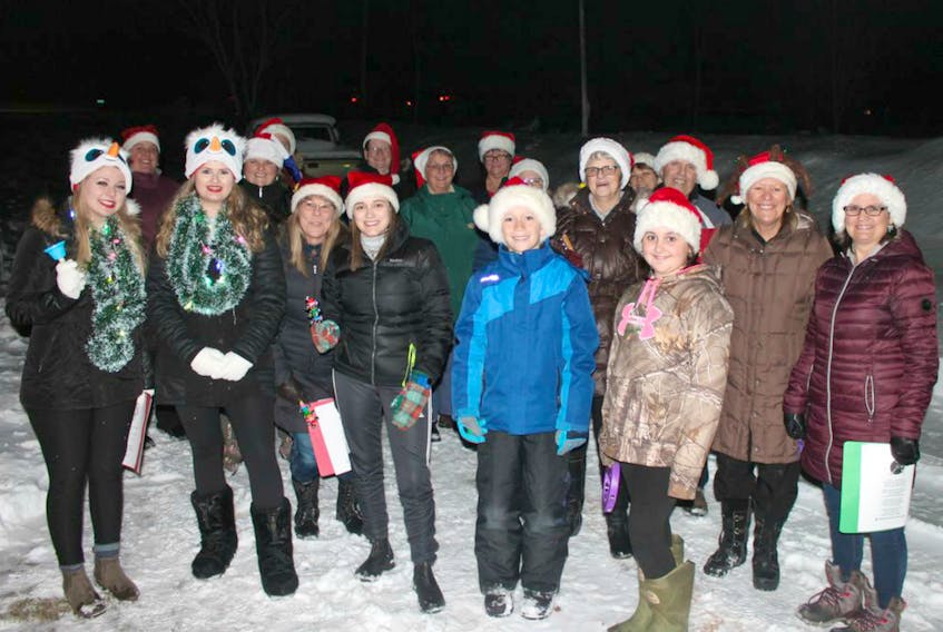 Christmas carolers spread their warmth on a cold, wintry night in Saint Chrysostome.