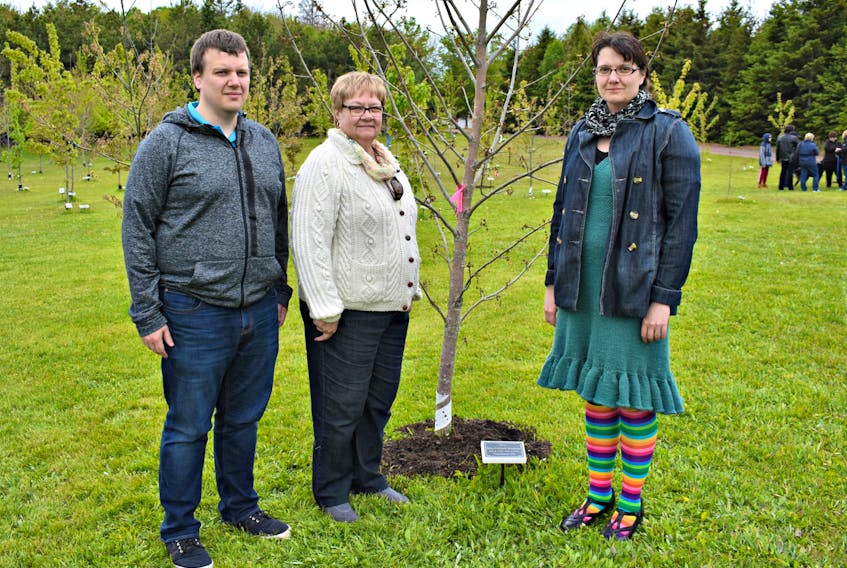 Tim Woodside, brother, Gaie Orton, mother, and Katie Puxley, sister dedicate a tree to M.E. in the Everlasting Forest at the International Children's Memorial Place.