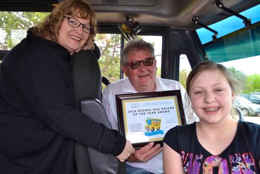 Donna MacLeod, left, secretary of the P.E.I. Home and School Federation and Ellerslie Elementary School graduating student, Cierra Gallant, congratulate Myles Noye on being chosen the Federation’s 2018 School Bus Driver of the Year. Noye is retiring at the end of the school year.