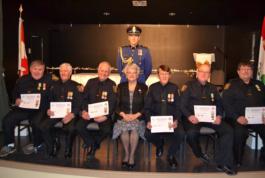 Lieutenant Governor Antoinette Perry presented Years-of-Service medals Saturday to several members of the Miminegash Fire Department. With her on stage are firefighters who received 40-year service medals, from left, Steve Gallant, Ronald Butler, Chief Wayne Gallant and Edward Butler, and firefighters with 30 years service, Brian Tremblay and Robert Wedge. In the background is Aide-de-Camp, Sinclair Walker.