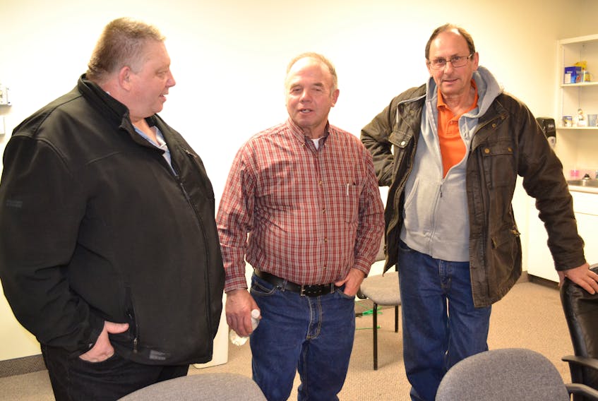 Ronnie MacWilliams, center, chairman of the P.E.I. Farm Practices Review Board, chats with fellow members of the board, Dan MacKinnon, left, and Edwin McKie. They, along with board member John Bysterveldt, comprised the board’s panel that met Wednesday to hear a Town of Alberton complaint over Westech Agriculture’s use of a composted fertilizer. At a request from the town’s lawyer, the board agreed to adjourn the panel so that more evidence can be obtained.
